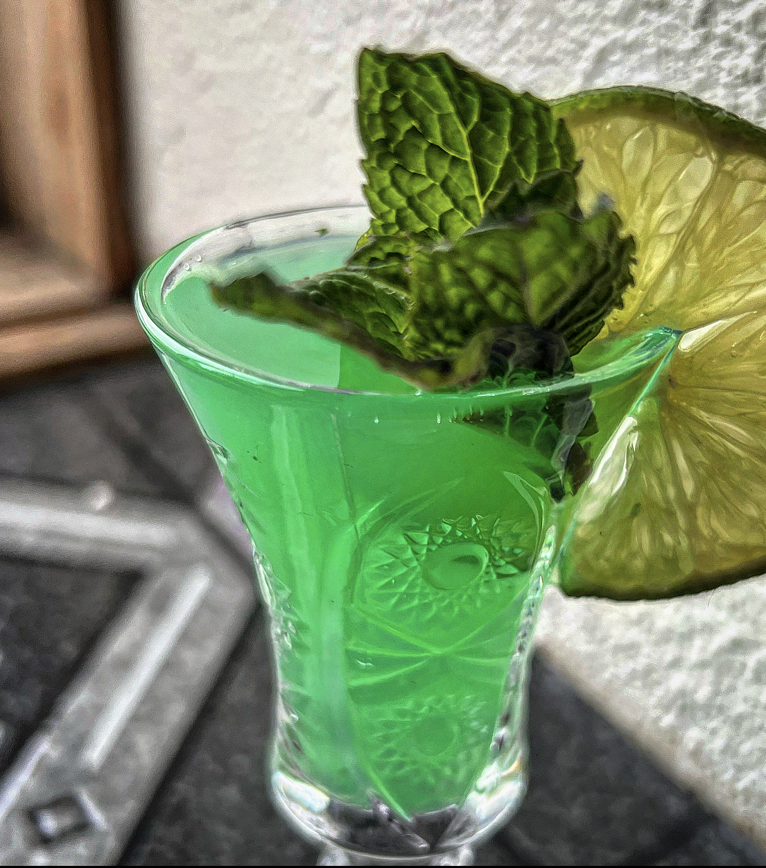 A bright green mint shooter with a lime wheel