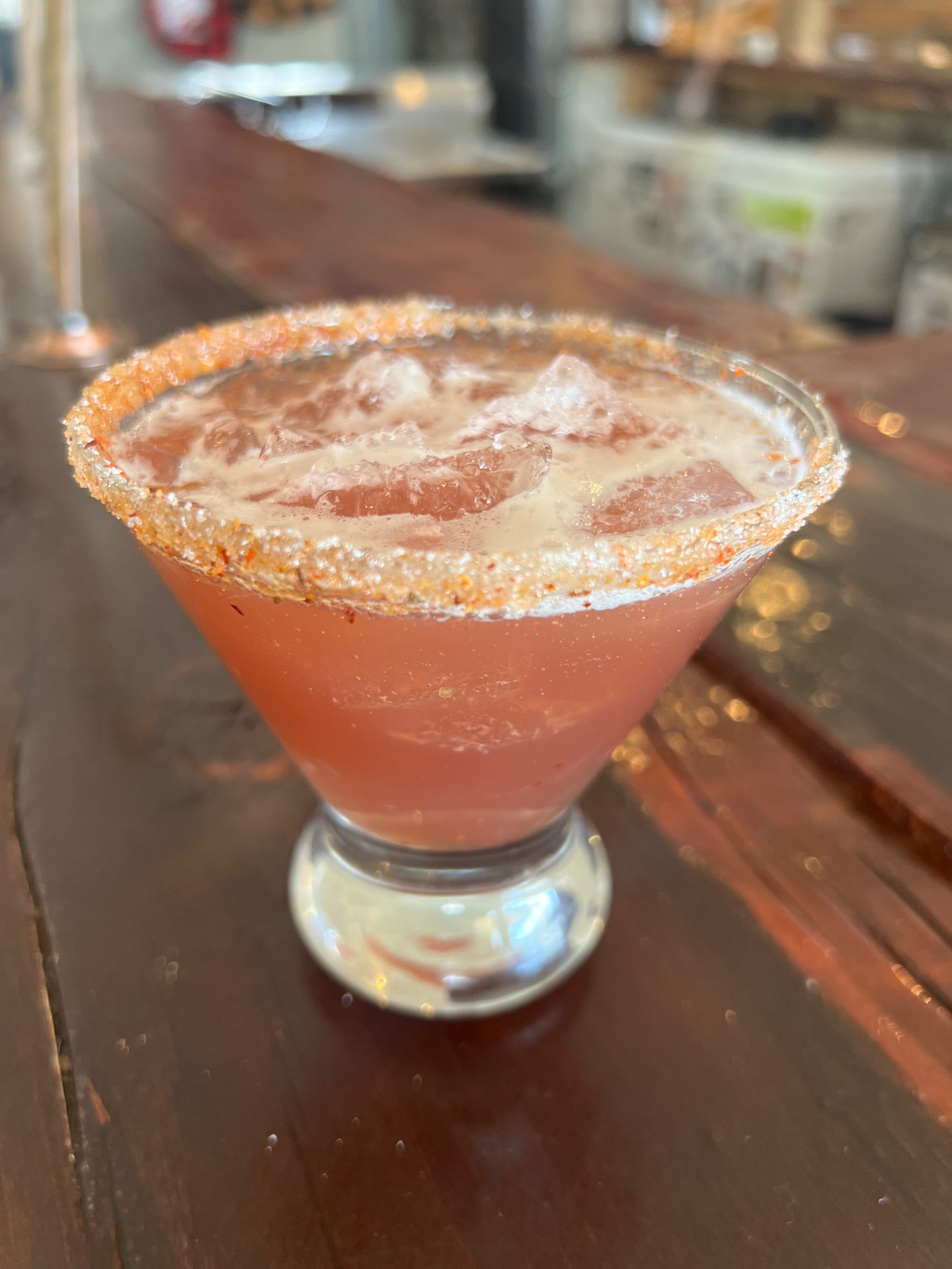A chili-sugar rimmed watermelon margarita on the bar