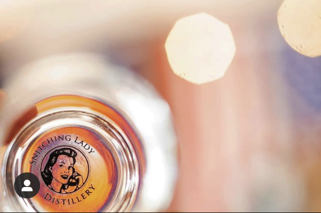 An overhead shot of a Snitching Lady bottle cap in warm light