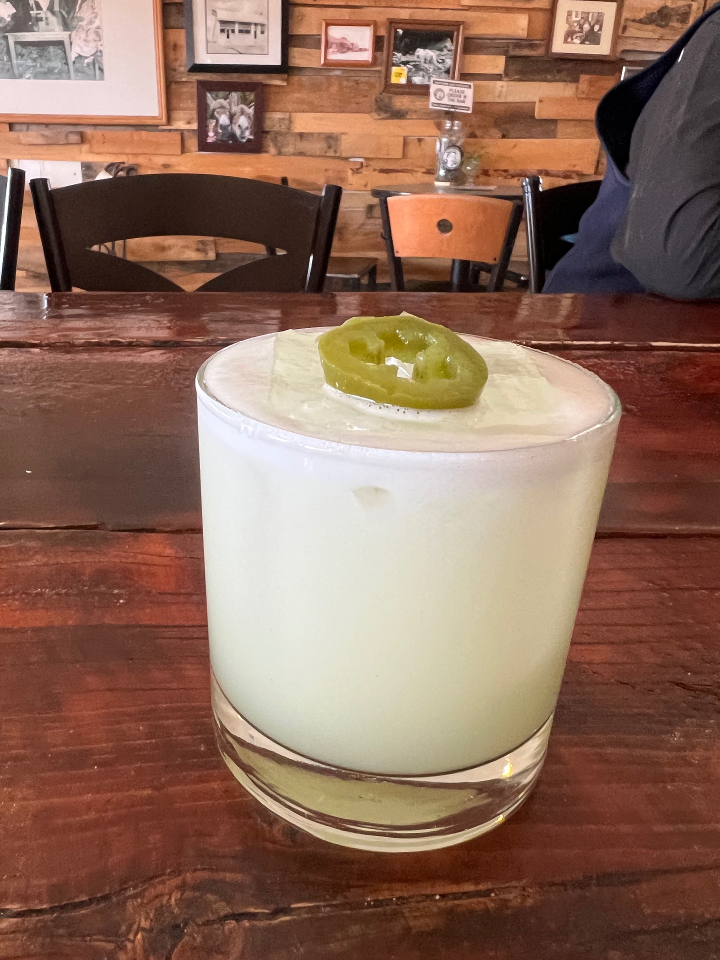 A frothy jalapeño whiskey sour on the reclaimed-wood bar