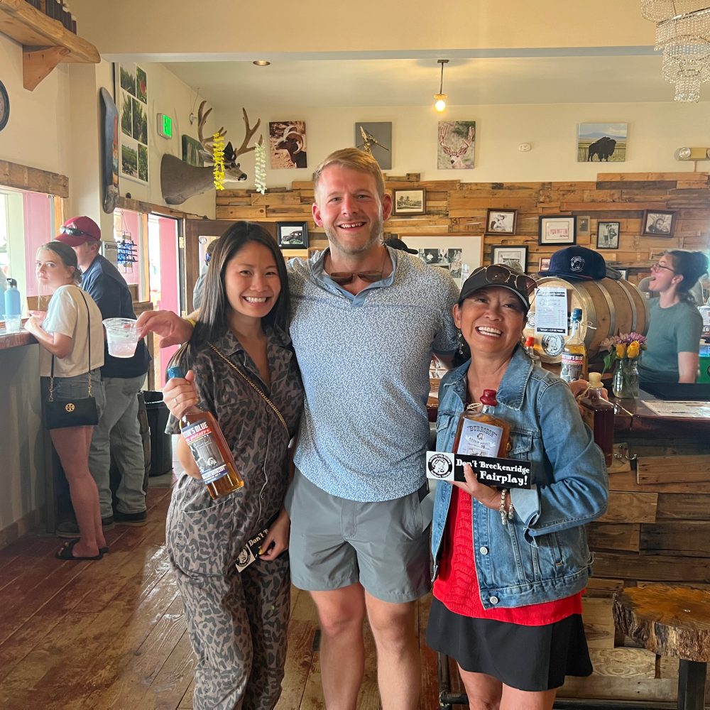 Friends raising bottles together in the tasting room