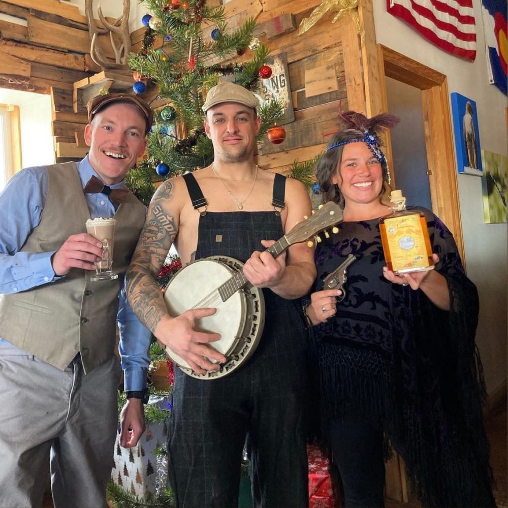 A costumed trio with a banjo at a holiday party