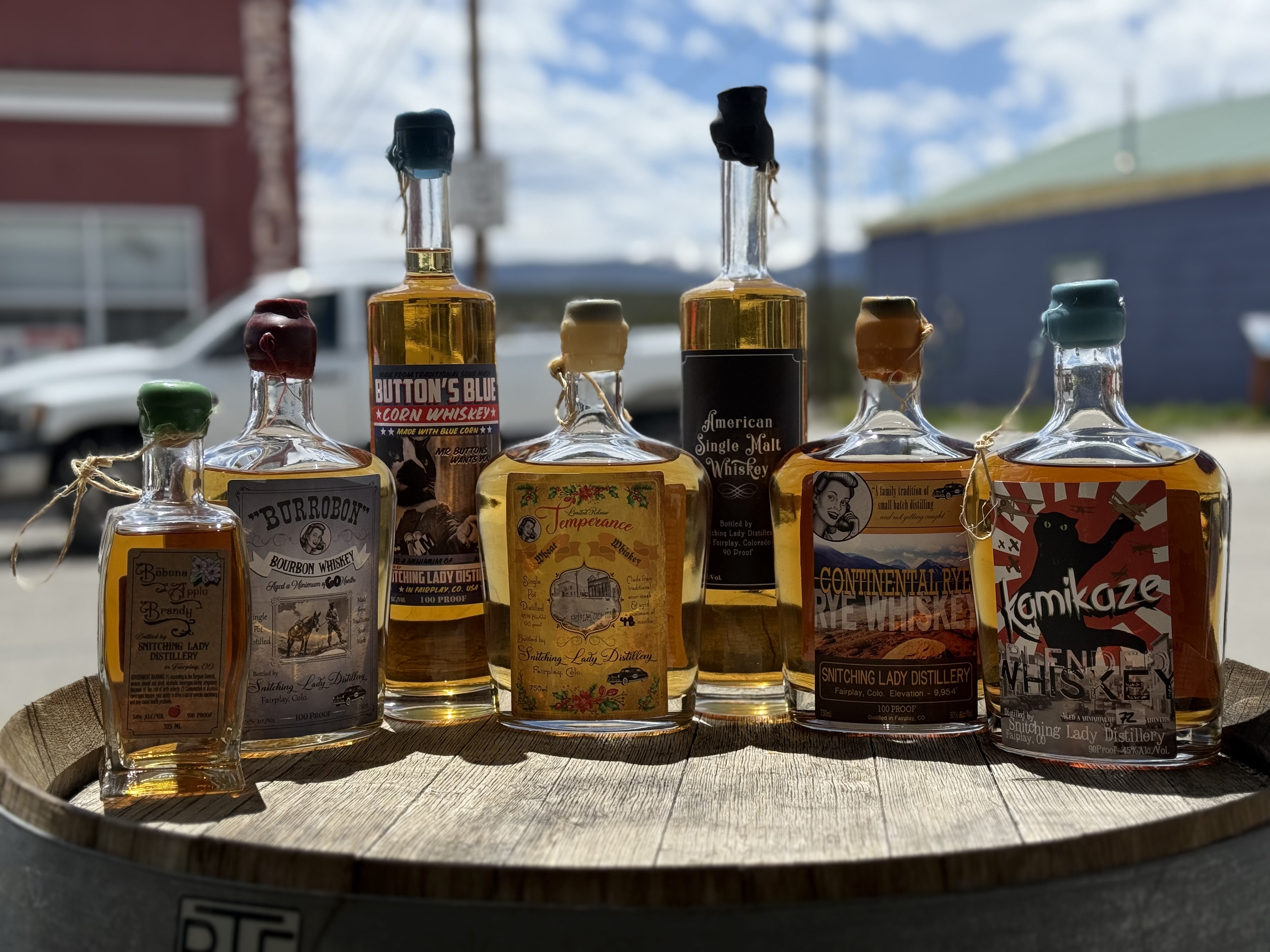 The Snitching Lady lineup on a barrel outside the distillery